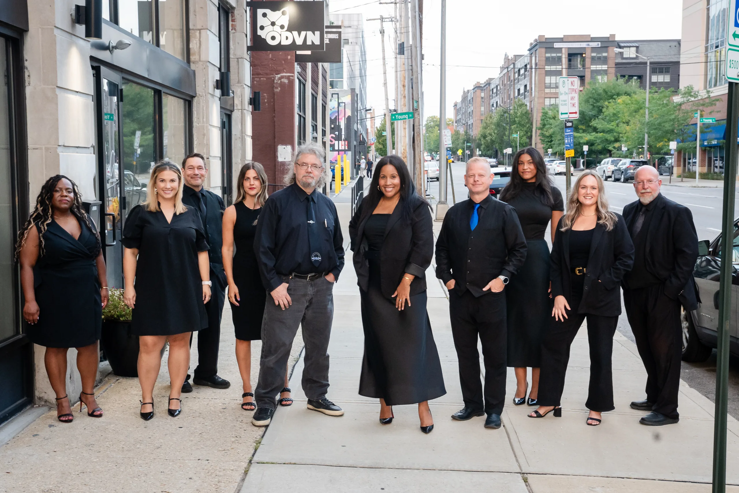 The D&M DJ Entertainment and The Planning Bee teams standing together on a city sidewalk